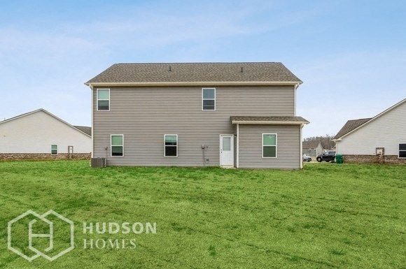 a house with a grassy yard in front of it