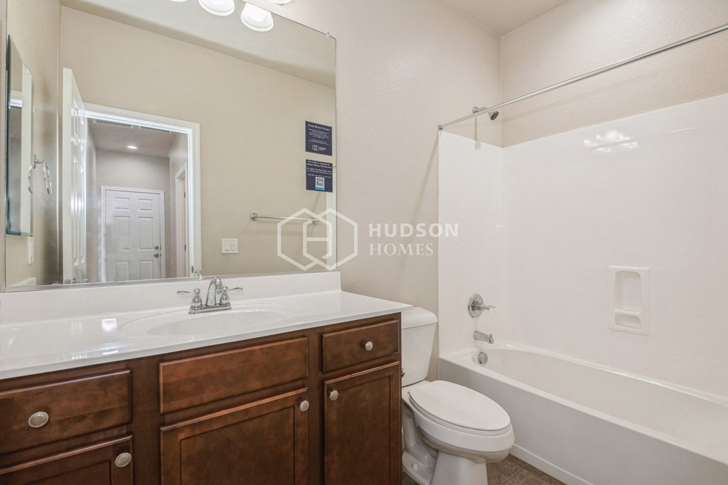 a bathroom with a sink and a toilet and a shower