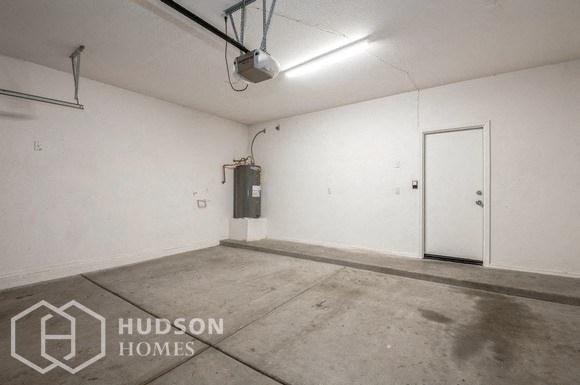 an empty room with a white wall and a door