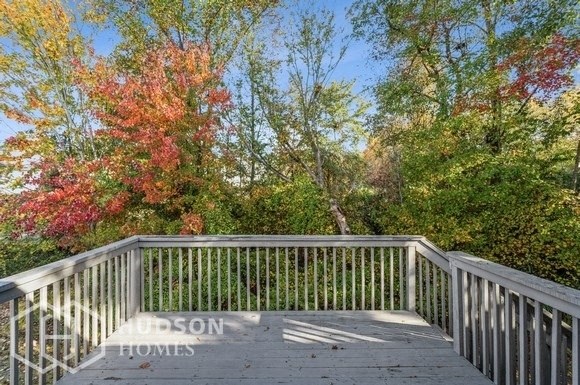 a wooden deck with trees in the background