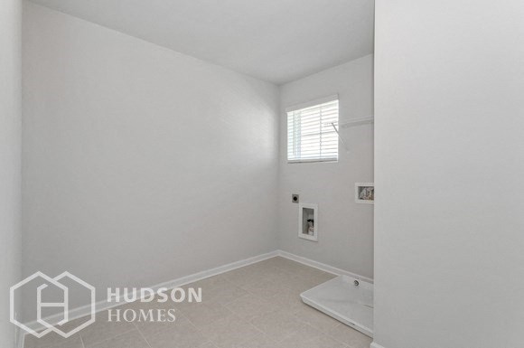 a white bathroom with a shower and a toilet in it
