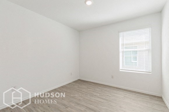 an empty room with white walls and a window