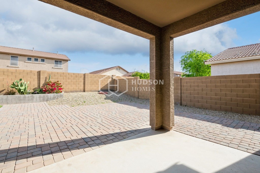 a renovated house with a large yard and a brick patio