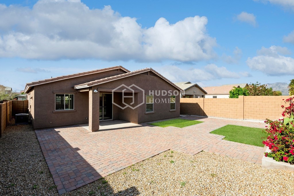 a house with a brick driveway and a lawn