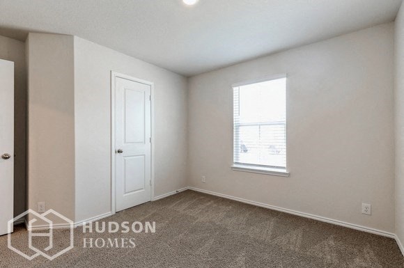 a bedroom with a white door and a window
