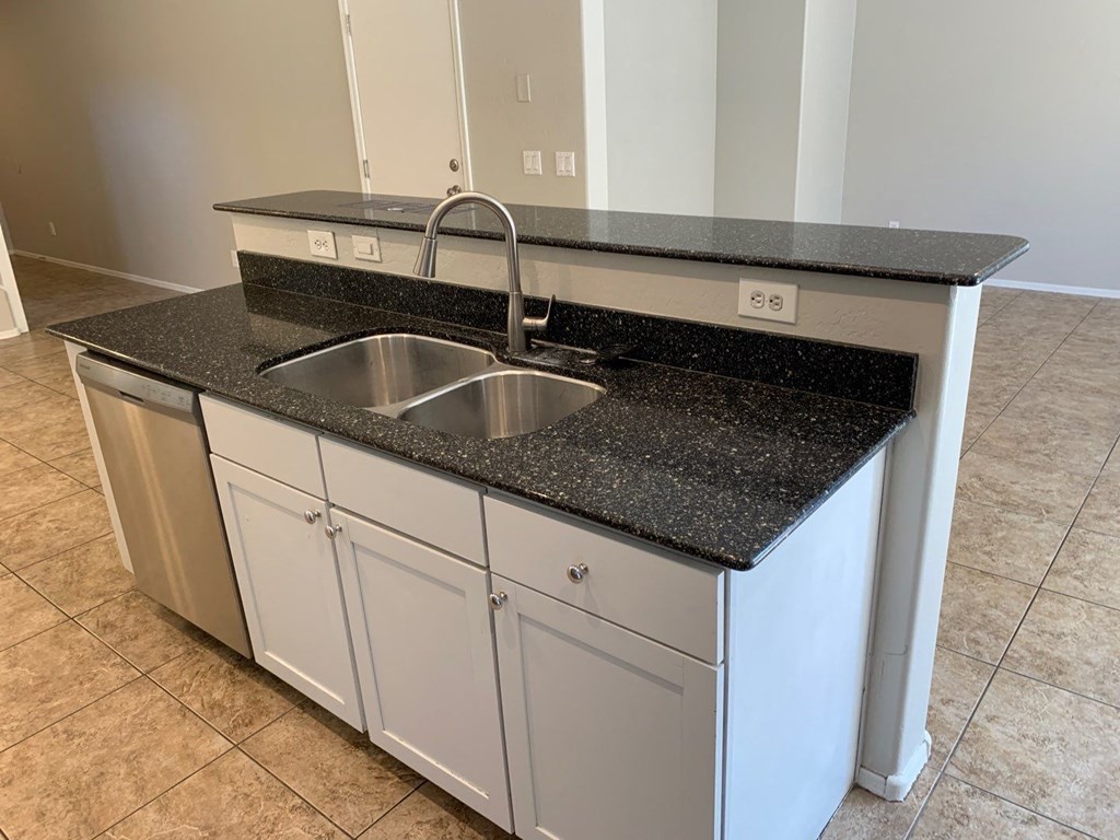 a kitchen with a sink and a counter top