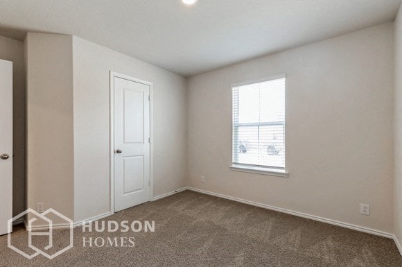 a bedroom with a white door and a window