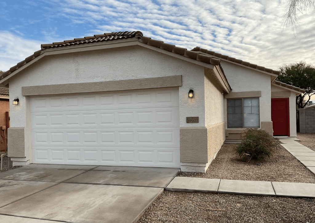 a white house with a white garage door