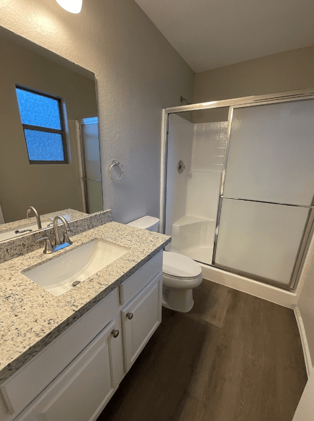 a bathroom with a sink toilet and shower