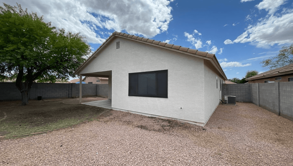 a white house with a big window in the side of it