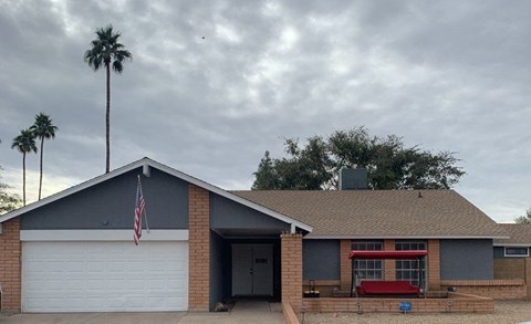 a house with an flag and a palm tree