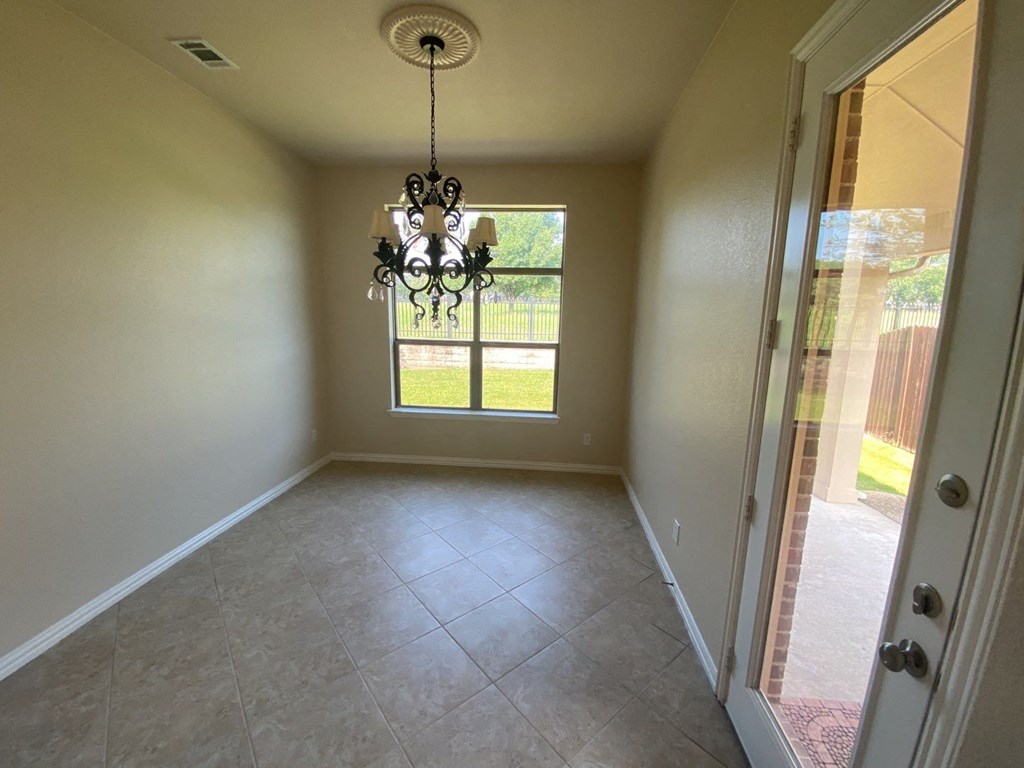 a dining room with a chandelier and a window