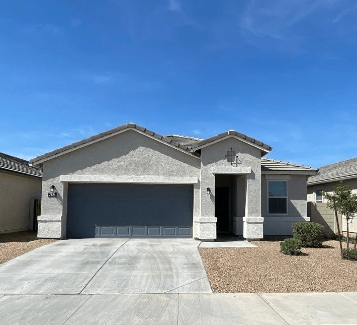 a house with a garage door in front of it