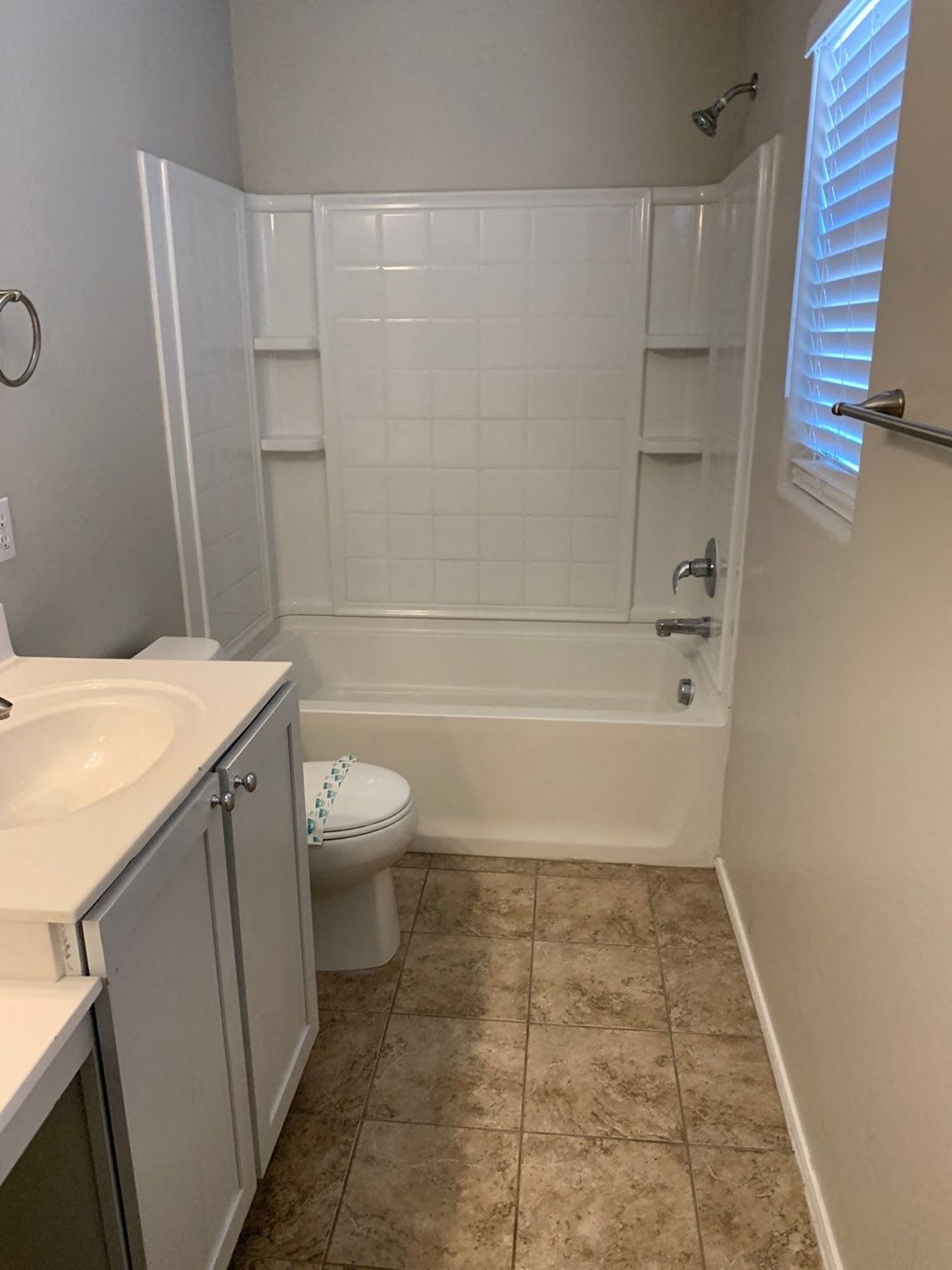 a bathroom with a toilet and a tub and a sink