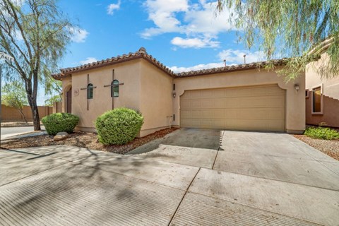 a home with a garage door and a driveway