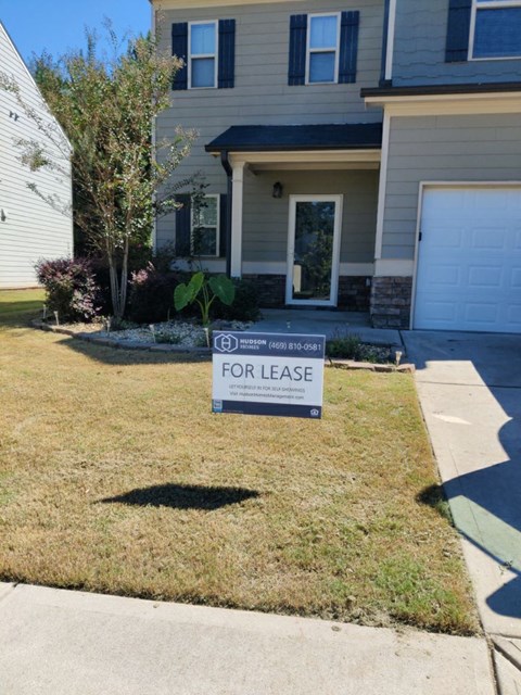 a for lease sign in front of a house
