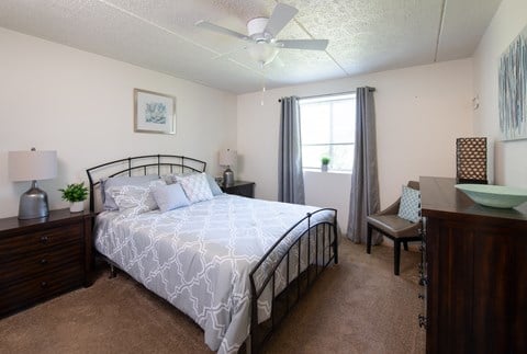 a bedroom with a large bed and a desk with a chair at North Pointe Commons, Pittsburgh