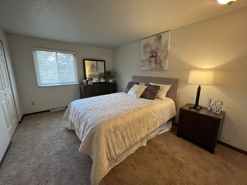 a bedroom with a bed and two night standsat Holiday Park Apartments, Pennsylvania
