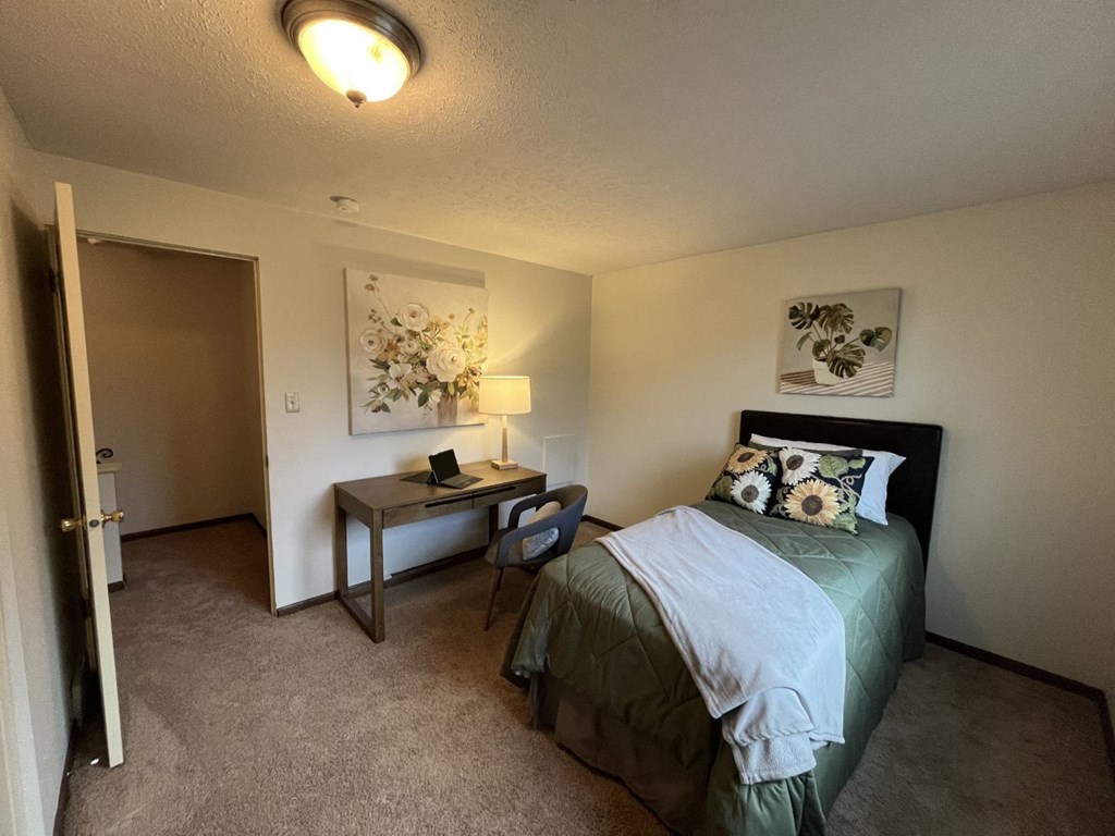 a bedroom with a bed and a deskat Holiday Park Apartments, Pennsylvania, 15239