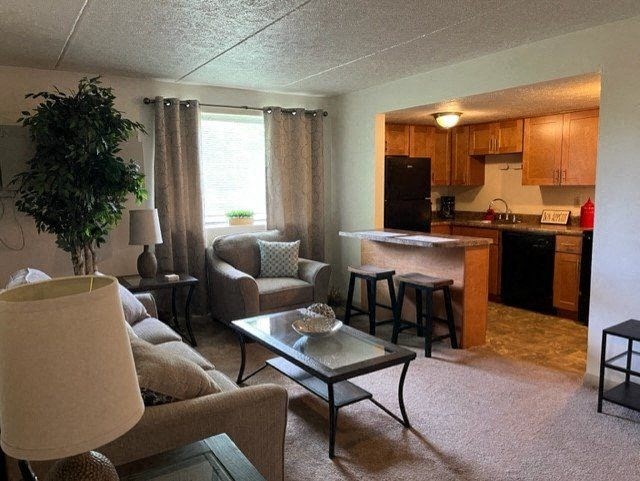 A living room with a couch, chair, and coffee table.