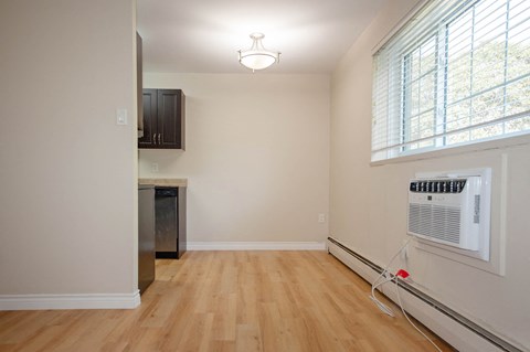 a living room with a wood floor and a window