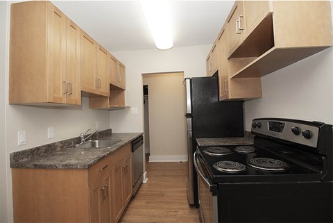 a kitchen with black appliances and wooden cabinets