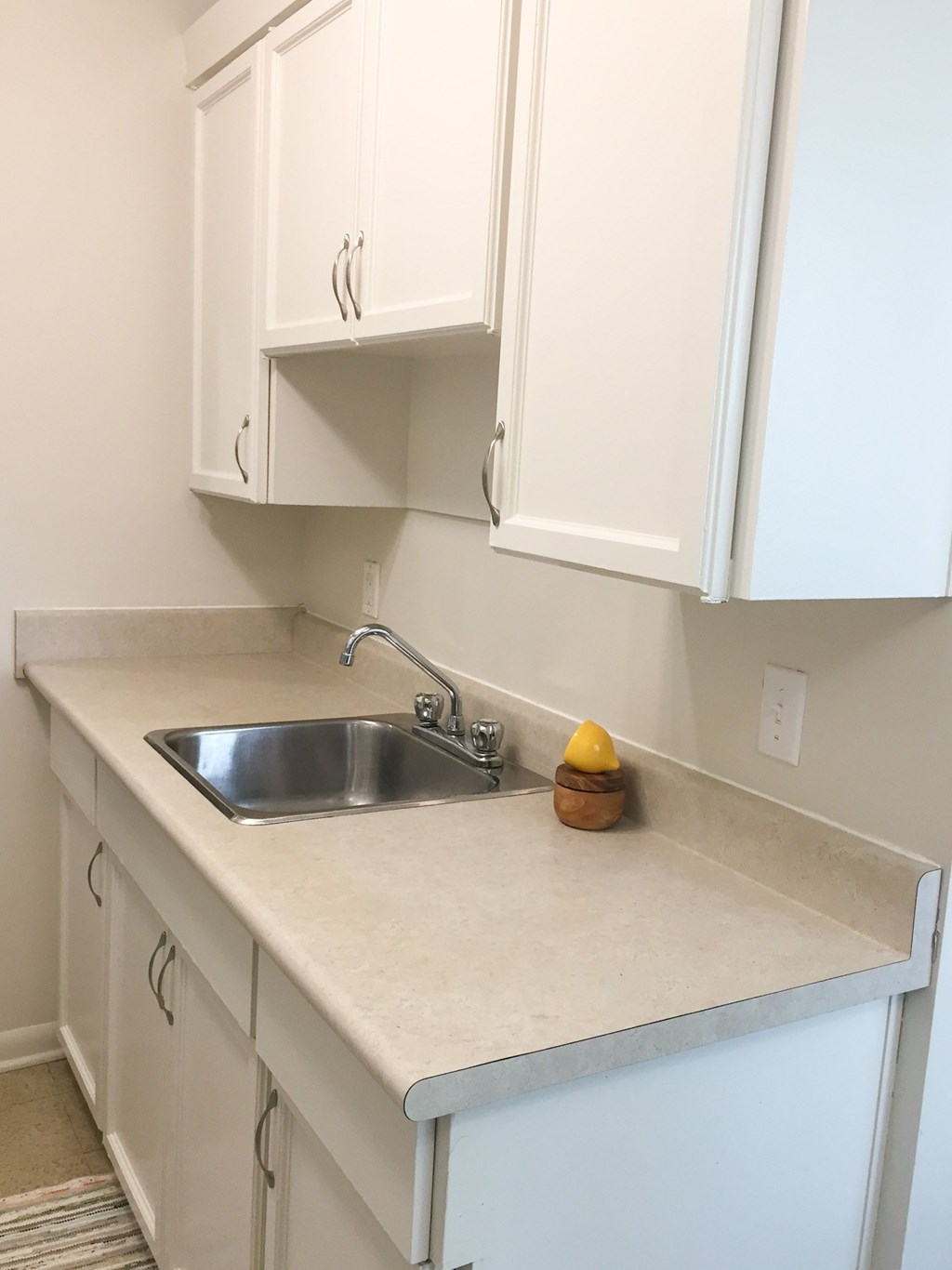 A kitchen with a sink and cabinets.