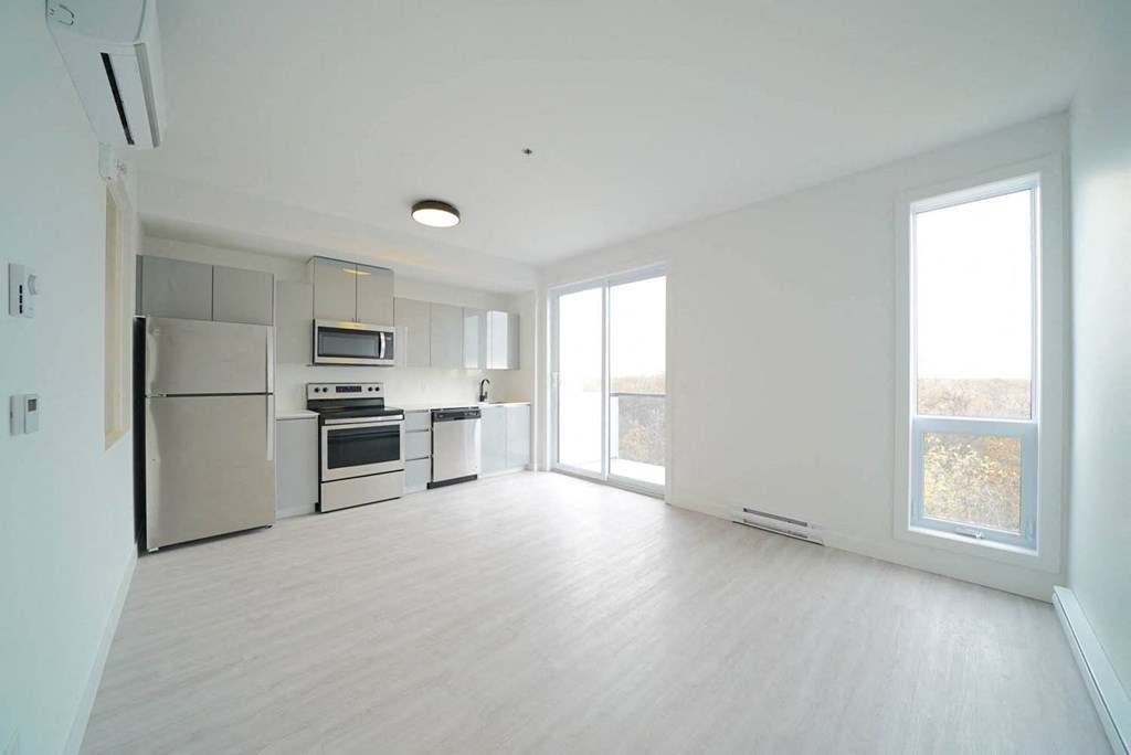 Kitchen and Living Area With Modern Finishings at 703 St. Anne's Road Apartments, Winnipeg, MB
