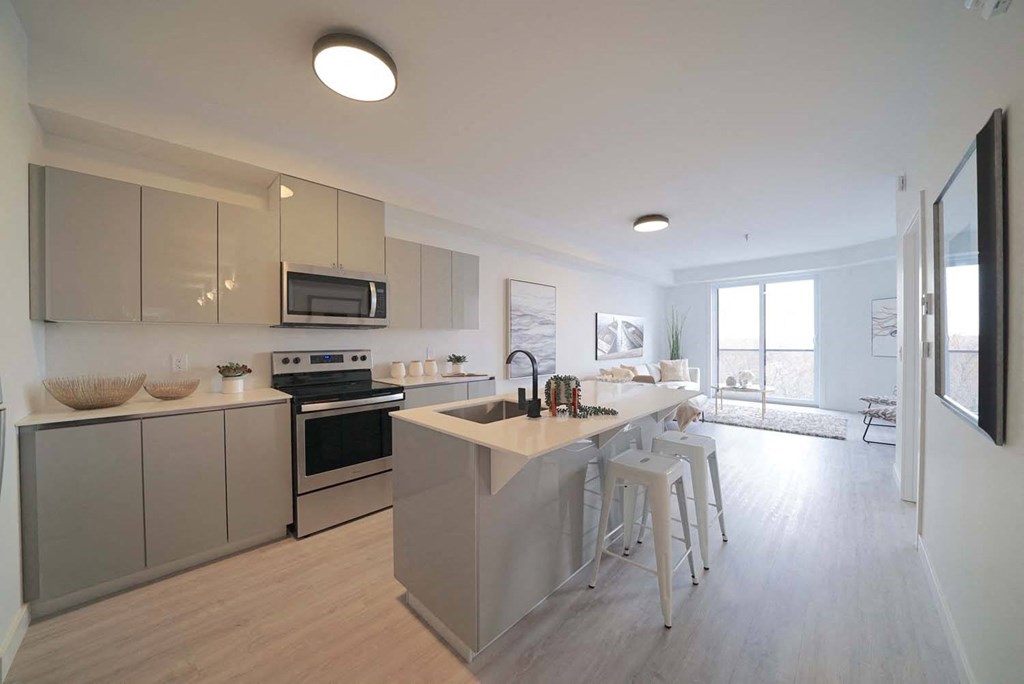 Modern Kitchen With Bar Counter at 703 St. Anne's Road Apartments, Winnipeg, MB