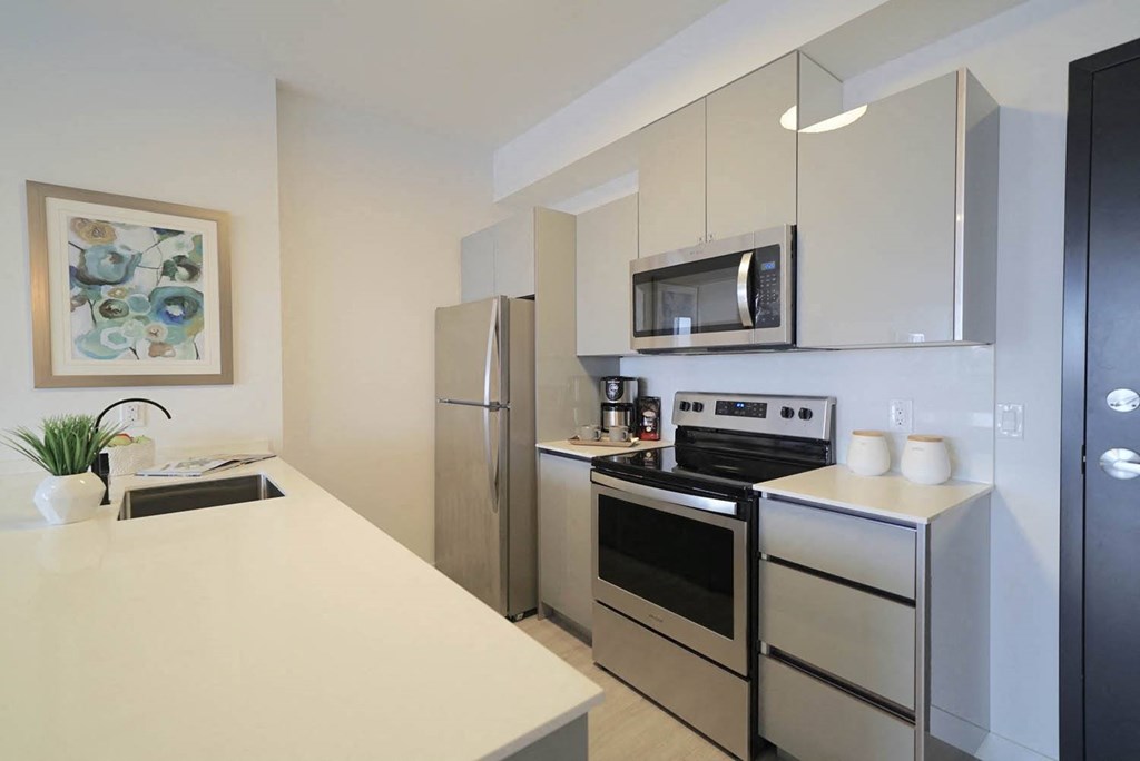 Modern Kitchen With Bar Counter at 703 St. Anne's Road Apartments, Winnipeg, MB