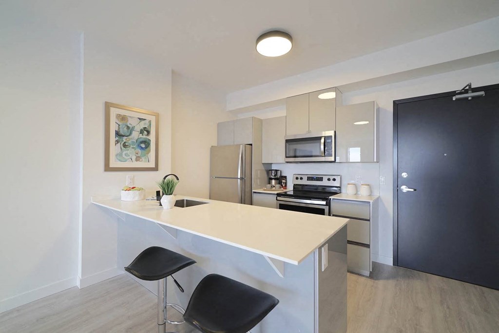 Modern Kitchen With Bar Counter at 703 St. Anne's Road Apartments, Winnipeg, MB