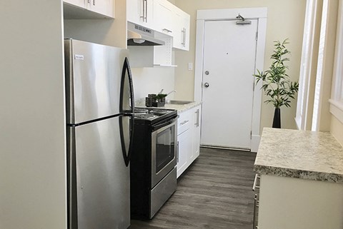 a kitchen with stainless steel appliances and a refrigerator