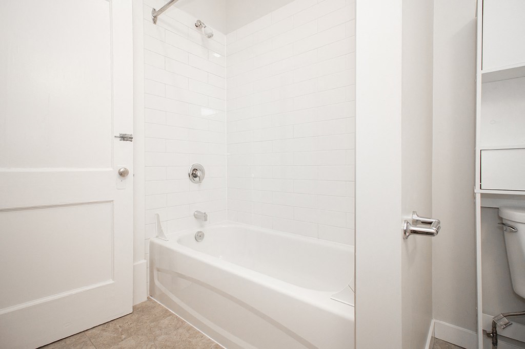 A bathroom with a tub in a two-bedroom suite for rent at 883 Grosvenor Avenue in Winnipeg