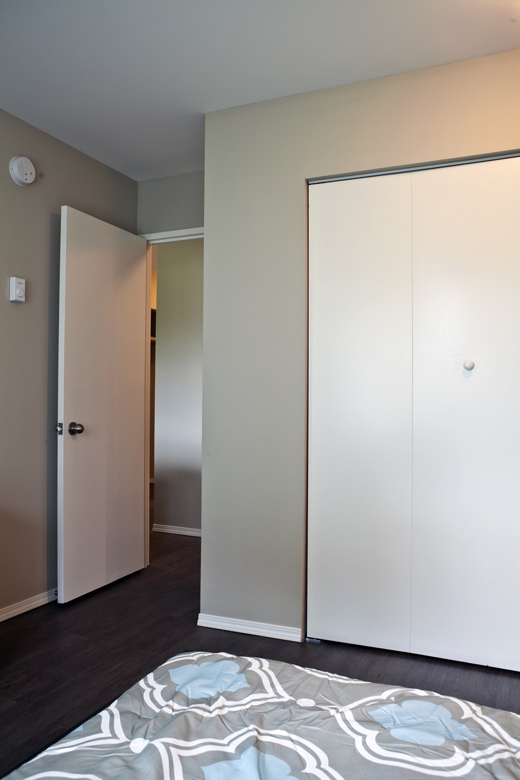 A white door is open to a hallway.