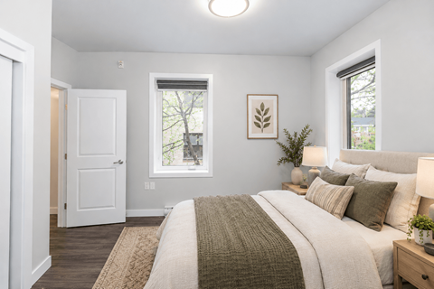 A bedroom with a large bed and a window.
