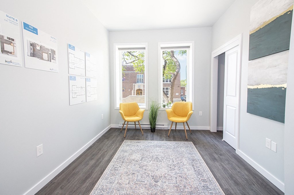 Rent in Winnipeg: a living room with two yellow chairs and a rug