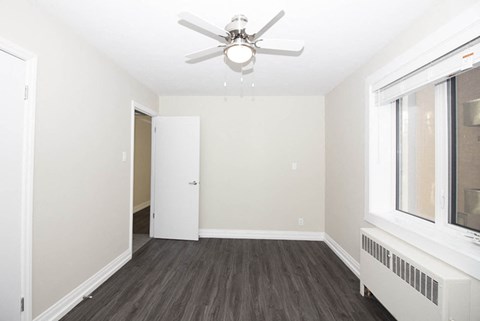 a living room with a ceiling fan and a window