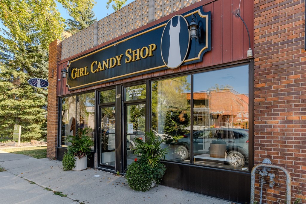 the front of a building with a sign that reads girl candy shop