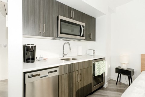 A modern kitchen with a microwave above the sink.
