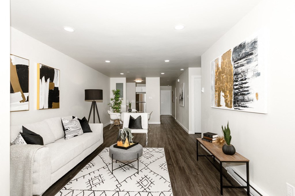 A modern living room with a white couch and a coffee table.