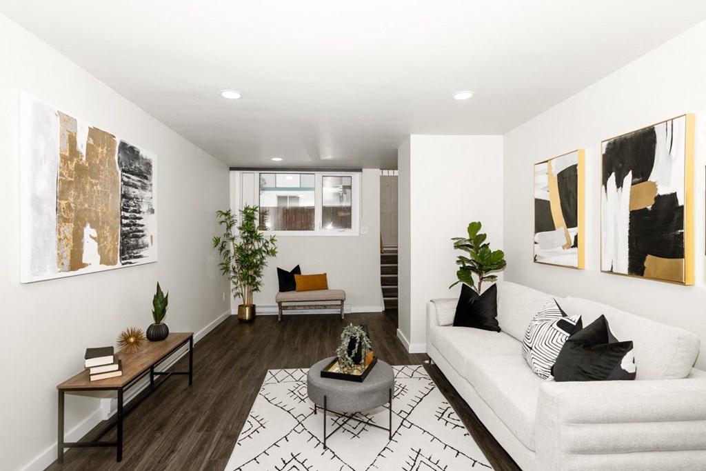 A living room with a white couch and a coffee table.