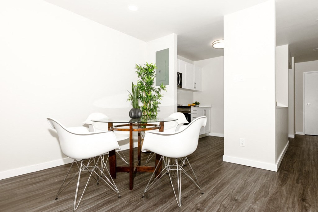 A dining room with a table and chairs.