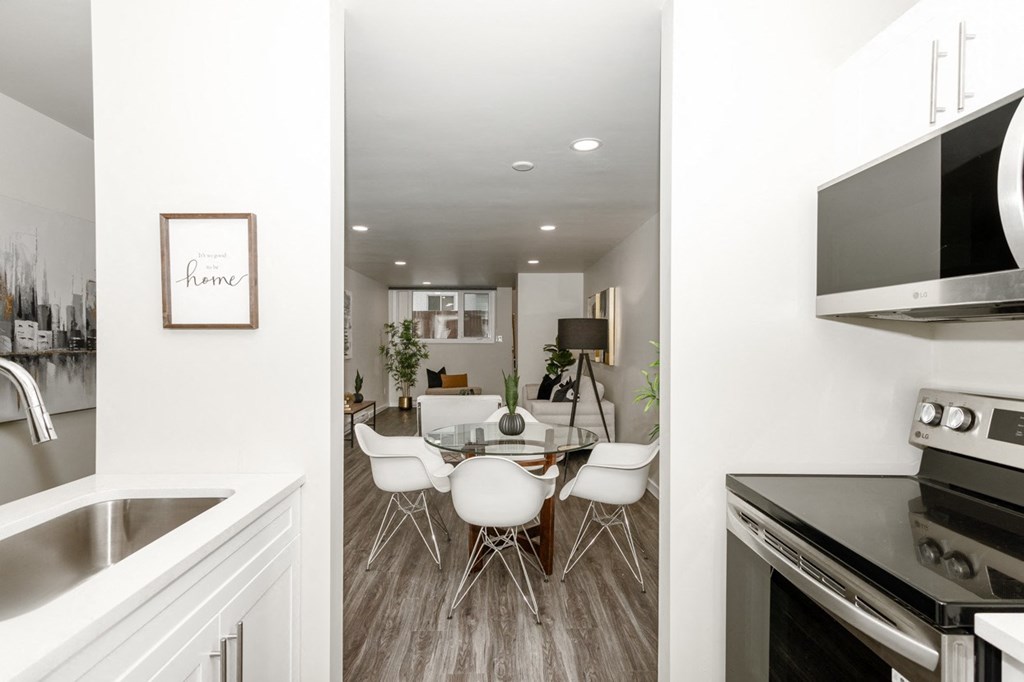 A modern kitchen with a dining table and chairs.