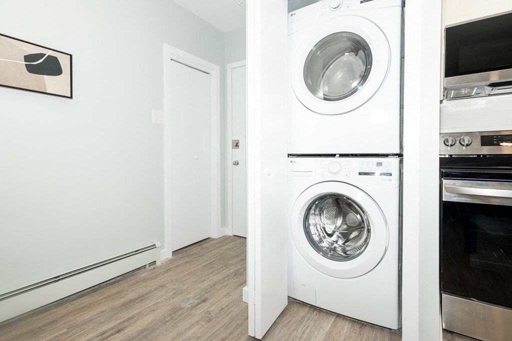 A white washing machine is in a laundry room.