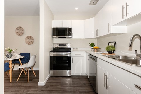 A modern kitchen with a dining table and chairs.