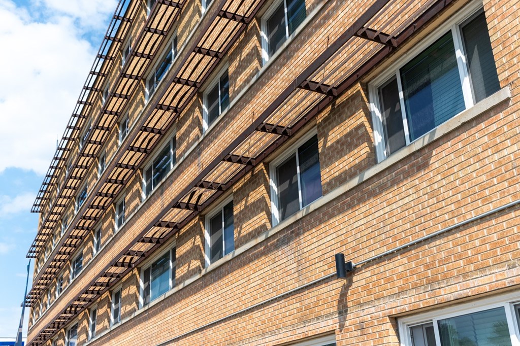A red brick building with a balcony on the second floor.