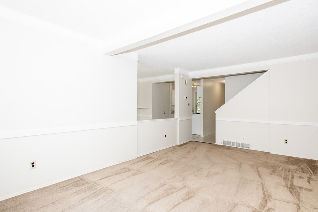 A room with a wooden floor and white walls.