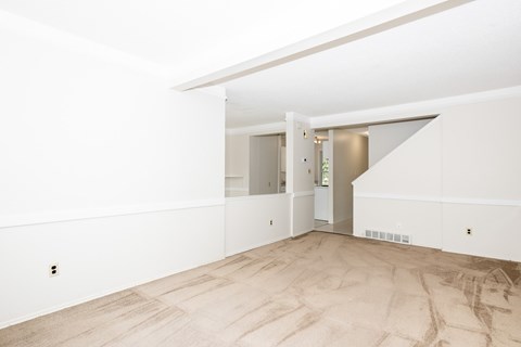 A room with a wooden floor and white walls.