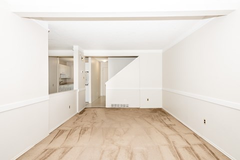 A room with white walls and wooden flooring.