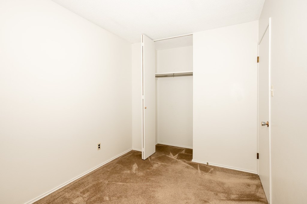 A room with a carpeted floor and white walls.